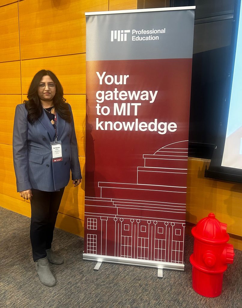 Dr. Karuna Kothapalli standing next to MIT Professional Education sign