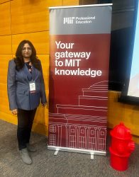 Dr. Karuna Kothapalli standing next to MIT Professional Education sign